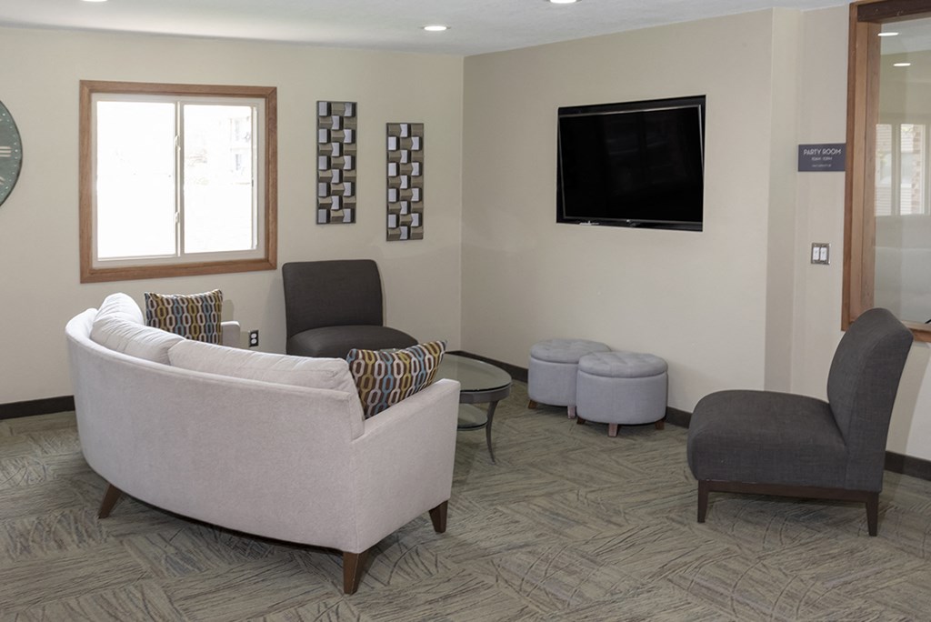 a living room with couches and chairs and a television