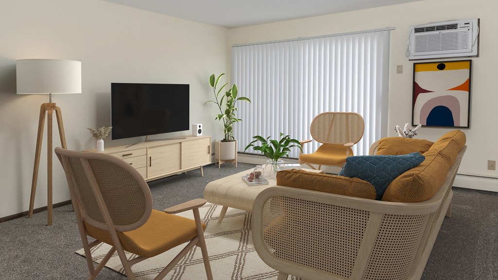 a living room with a couch and chairs and a television