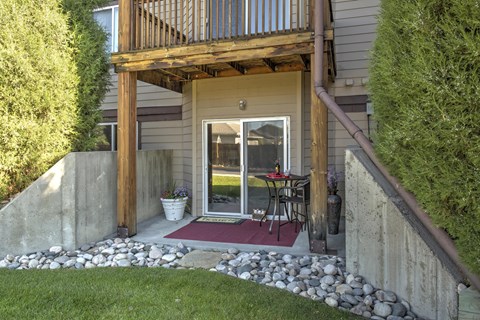 Private Patio with Rock Beds, Sliding Glass Door, and Path to Grass