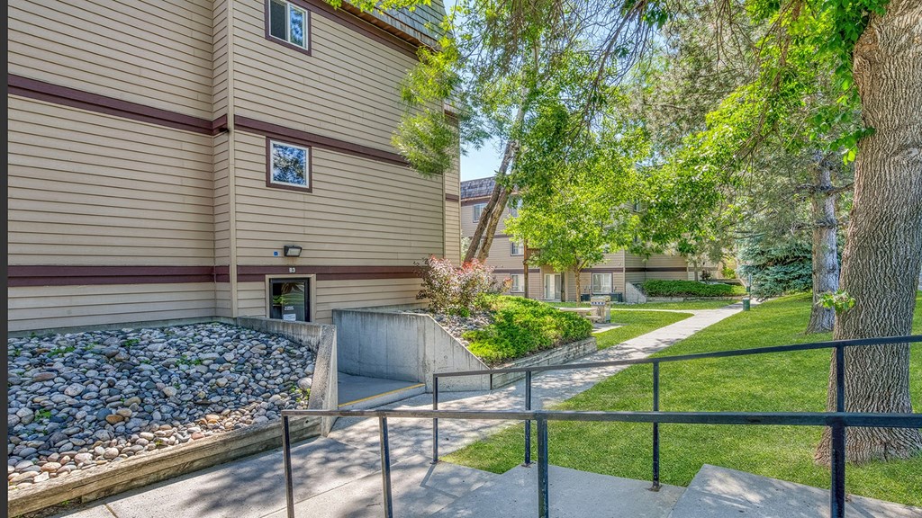 a house with a path and trees in front of it