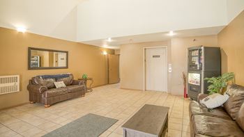 a living room with couches and a coffee table and a television