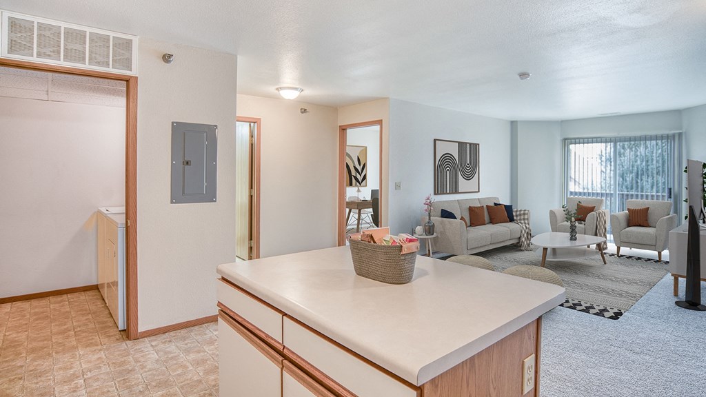 an open living room and kitchen with a living room with a couch