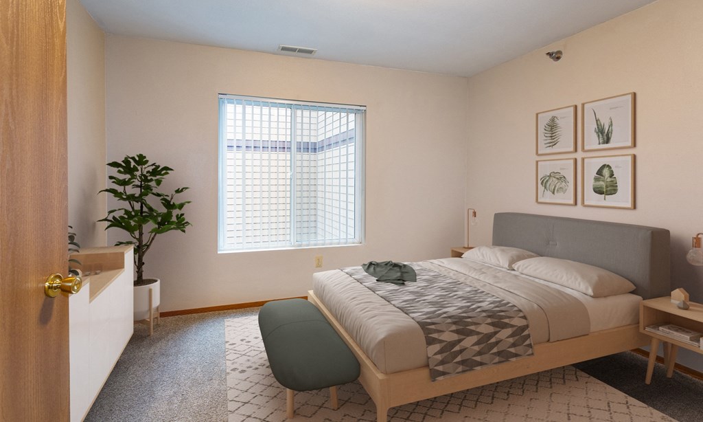 a bedroom with a bed and a large window