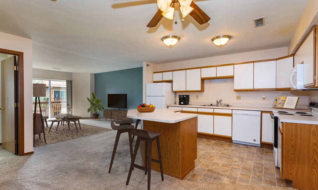 a kitchen with white cabinets and a white counter top