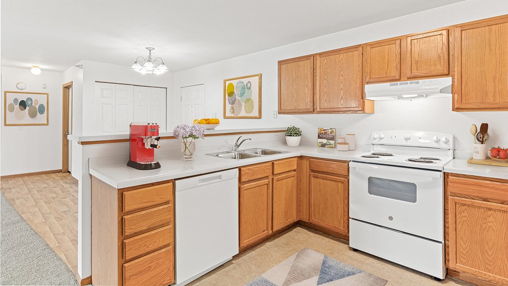 a kitchen with white appliances and wooden cabinets