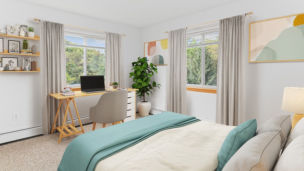 a bedroom with a bed and a desk with a computer