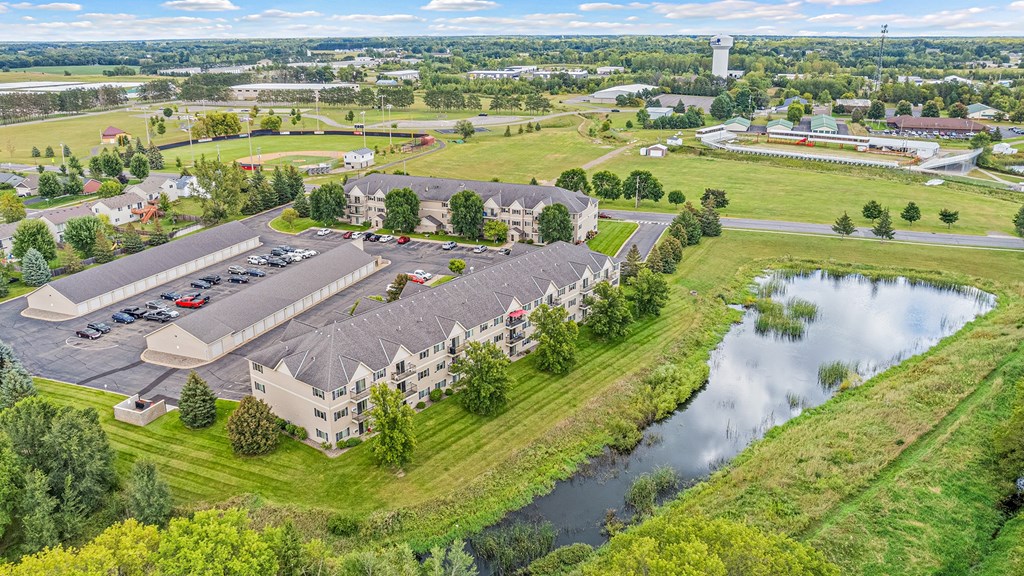 an aerial view of a building next to a body of water