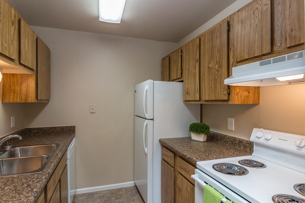 Full Kitchen with Wood Cabinets, White Appliances and Laminate Countertops