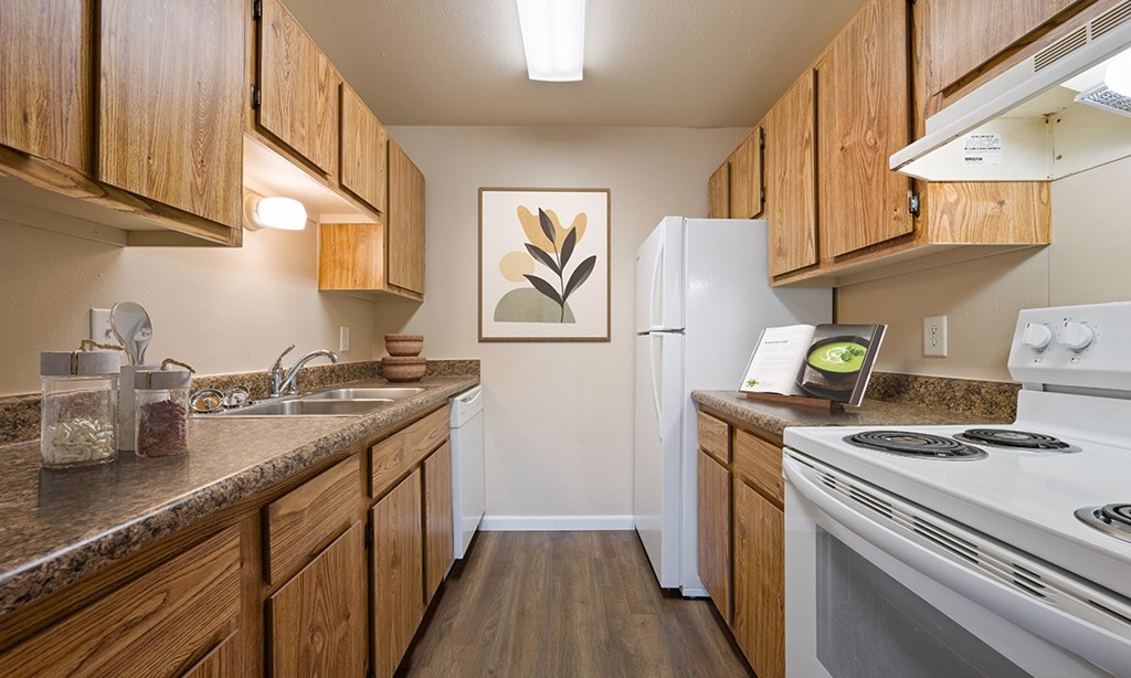 A kitchen with wooden cabinets and a white refrigerator.
