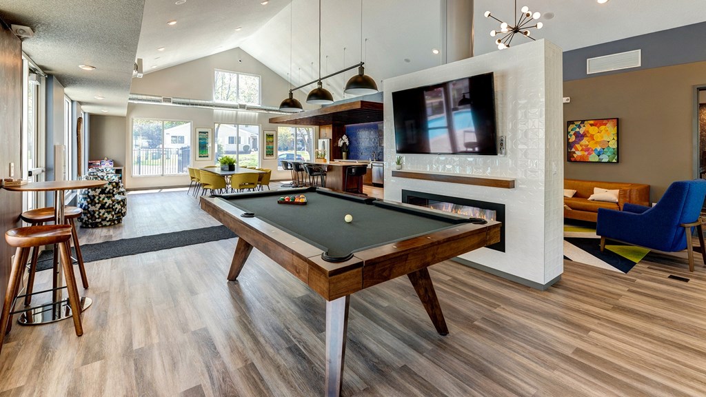 an open living room with a pool table and a tv