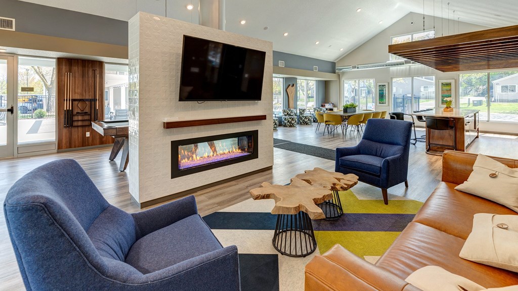 a living room with couches and chairs and a fireplace