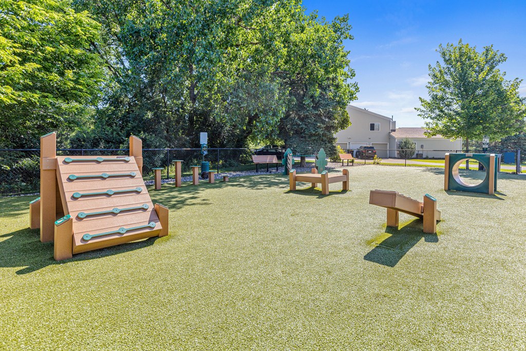 A playground with a slide, swings, and a bench.