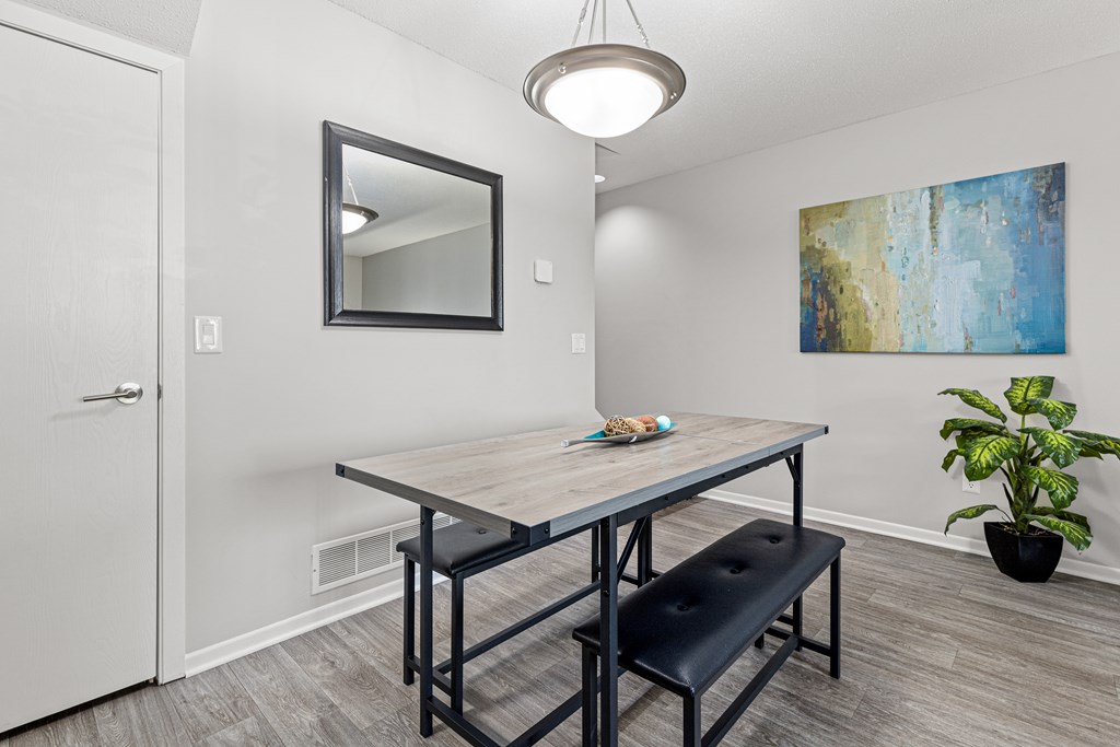 A dining room with a wooden table and bench.