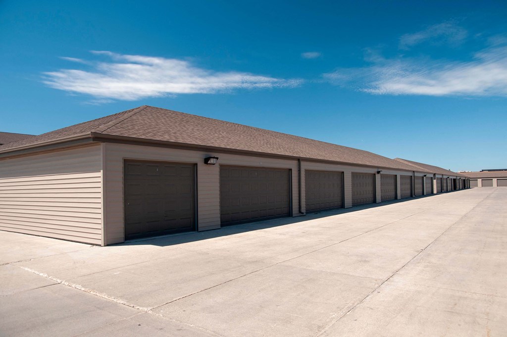 a row of garages with a blue sky in the background