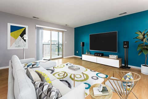 a living room with a blue wall and a couch and a television