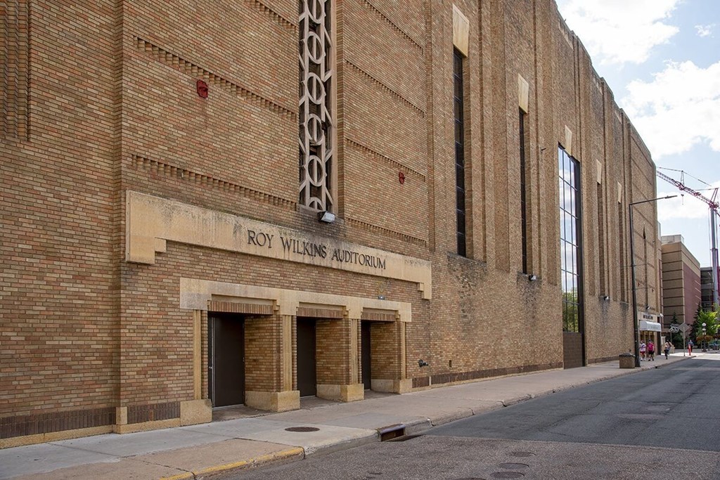 a large brick building with a sign that reads rwb williams american