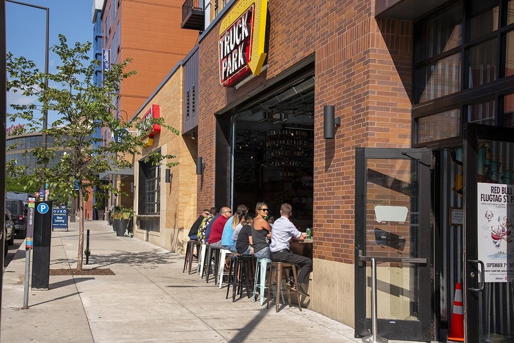a group of people sitting outside of a restaurant