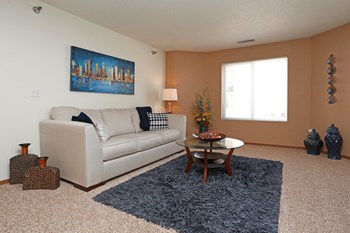 Cozy carpeted living room off the separate dining space complete with a window giving ample natural light. - Photo Gallery 3