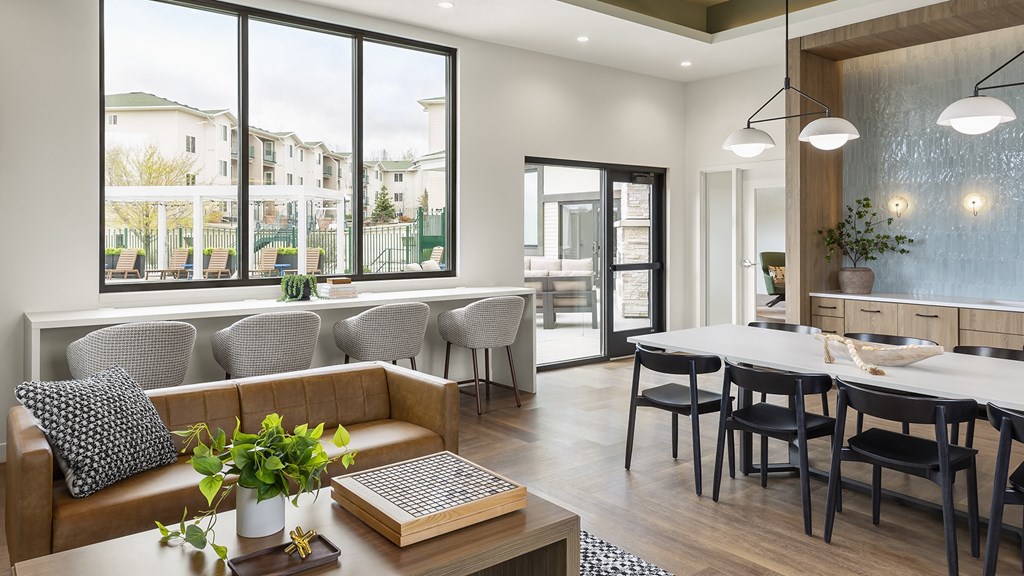 a living room and dining room with a table and chairs
