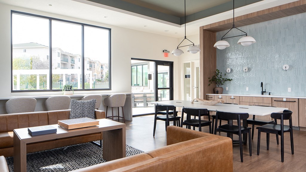 a dining room with tables and chairs and a large window