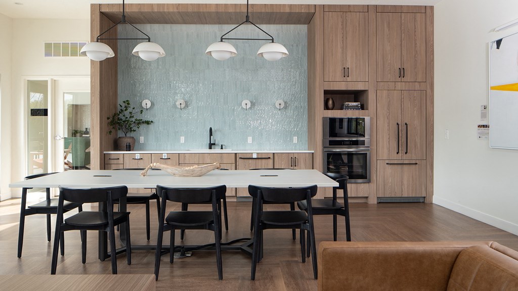 a dining room and kitchen with a large table and chairs
