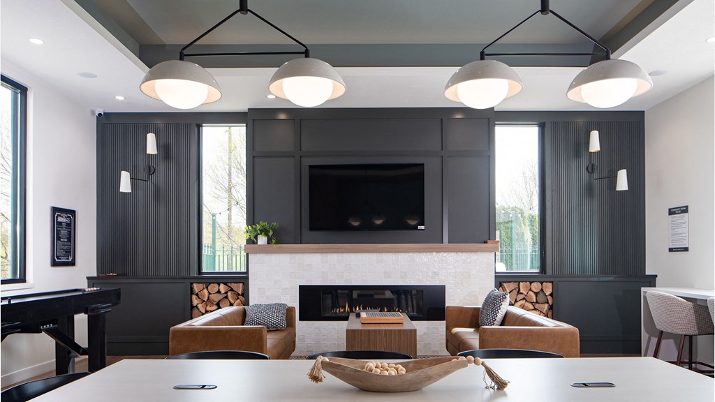 a living room with a fireplace and a table and chairs
