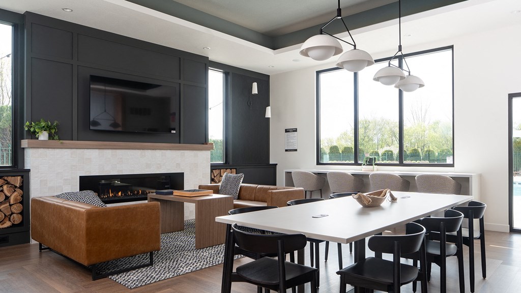 a living room with a fireplace and a table and chairs