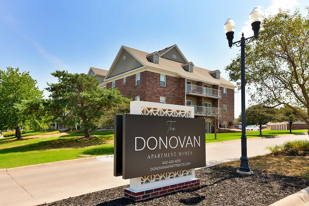 Homes sign in front of a brick building at The Donovan Apartment Homes, Nebraska, 68516