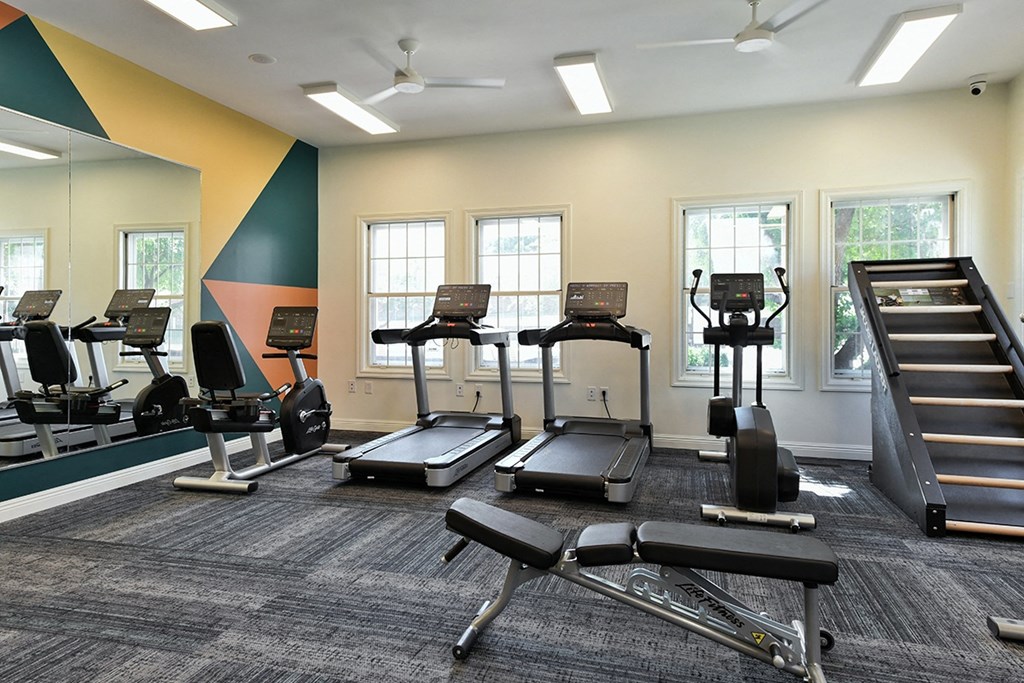 A gym with treadmills, elliptical machines, and a stair climber at The Donovan Apartment Homes, Lincoln, Nebraska