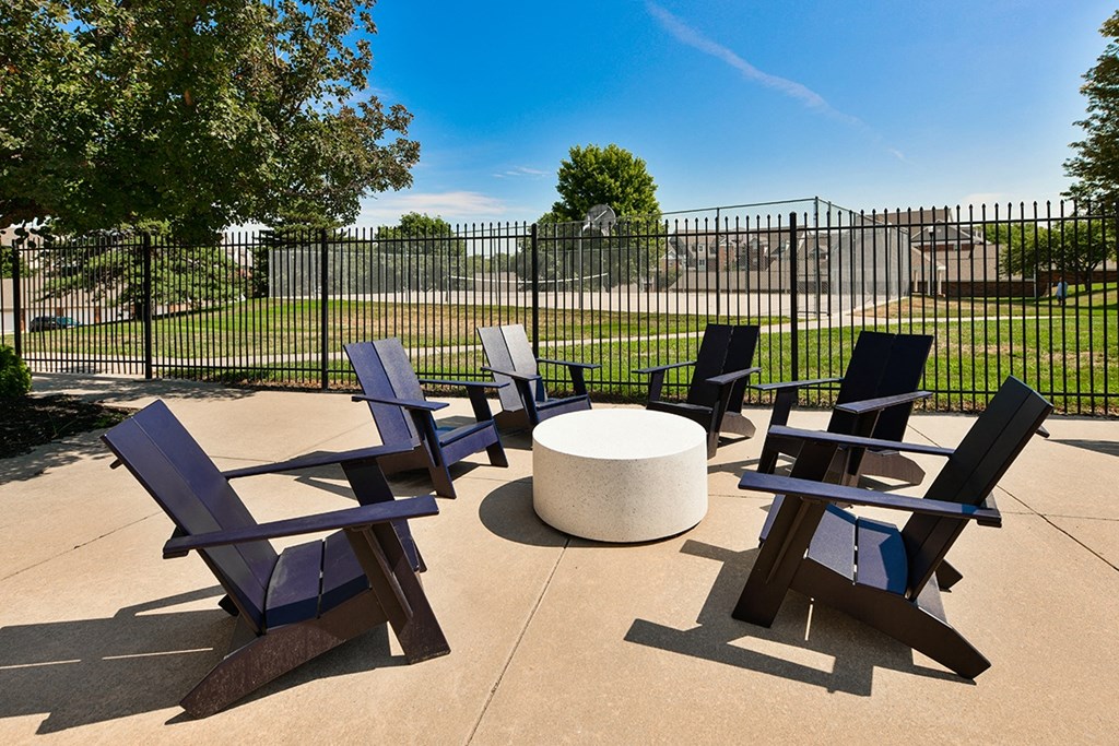 A set of four chairs and a table are arranged on a patio at The Donovan Apartment Homes, Lincoln