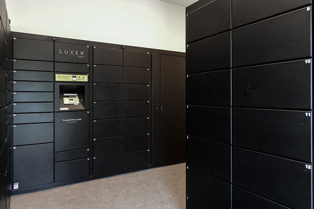 A row of black lockers with the word LUXER on the top left at The Donovan Apartment Homes, Lincoln, NE