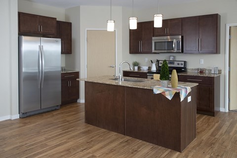 Kitchen with Dark Wood Cabinets, Island and Appliances