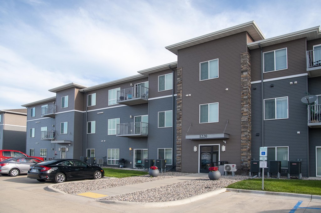 Exterior The Gardens Apartments Entrance and Parking Lot