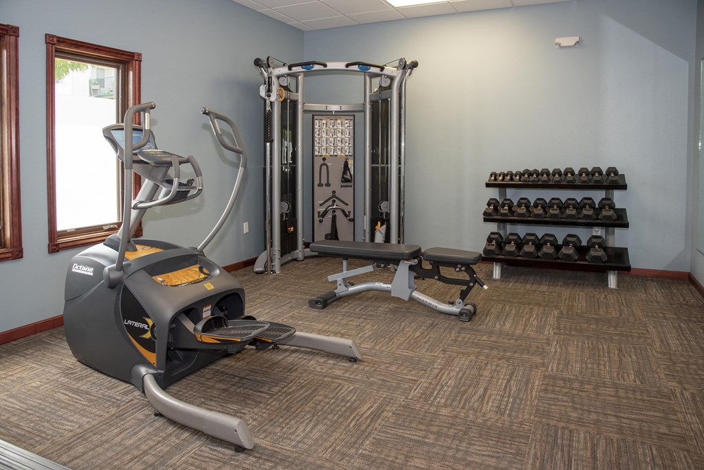 Weights and cardio equipment all available for use in the fitness center.
