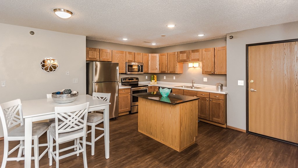 a kitchen and dining room with a white table and chairs