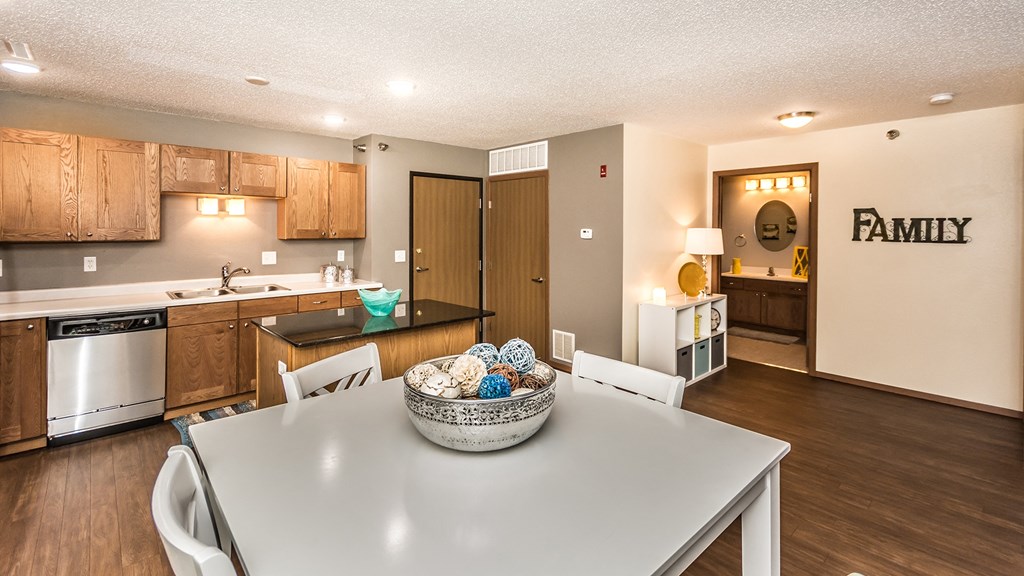 a dining room table with a bowl of easter eggs on it in a kitchen