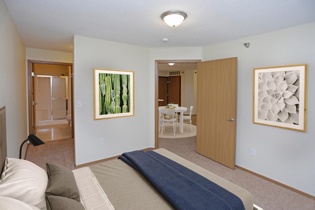 Spacious bedroom leading into a private bathroom.