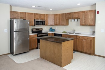 Spacious kitchens with stainless steel appliances and tons of cabinet space. - Photo Gallery 4