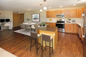 Bright modern kitchen featuring a casual dining island and a separate dining area. - Photo Gallery 2