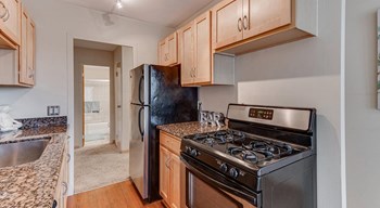Kitchen with light wood cabinets, black/stainless steel aplliances - Photo Gallery 2