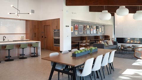 a dining room and living room with a table and chairs