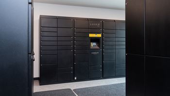 a row of lockers in a room with one door open at The Bosk Apartment Homes, Woodbury, MN, 55125