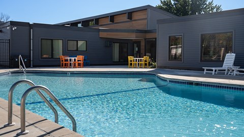 a swimming pool with a house in the background at The Bosk Apartment Homes, Minnesota