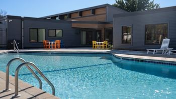 a swimming pool with a house in the background at The Bosk Apartment Homes, Woodbury, Minnesota
