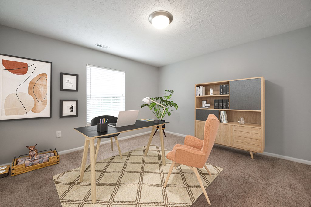 Home office with desk and laptop, bookshelf and dog bed at The Donovan Apartment Homes, Nebraska, 68516