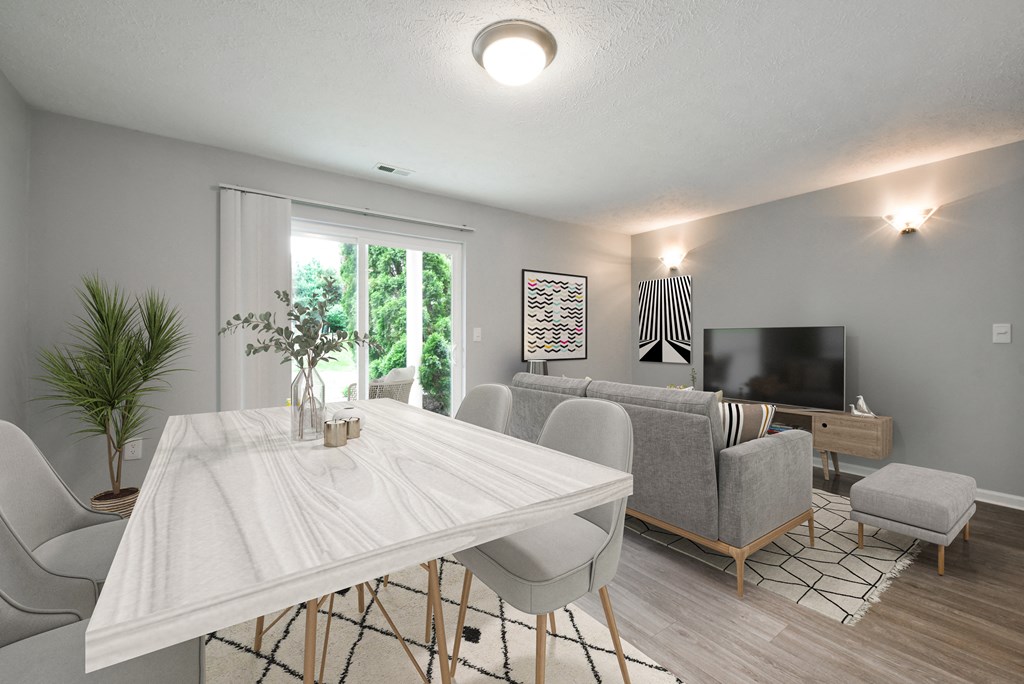Living room with couch, TV and white dining table with plant