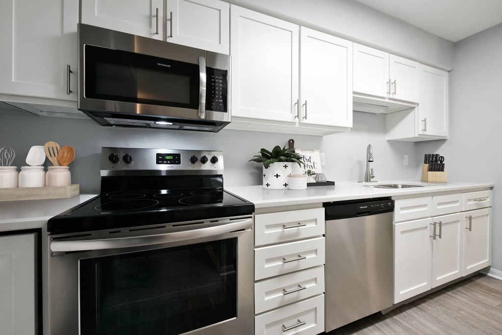 Kitchen with white cabinets and stainless steel appliances at The Donovan Apartment Homes, Nebraska