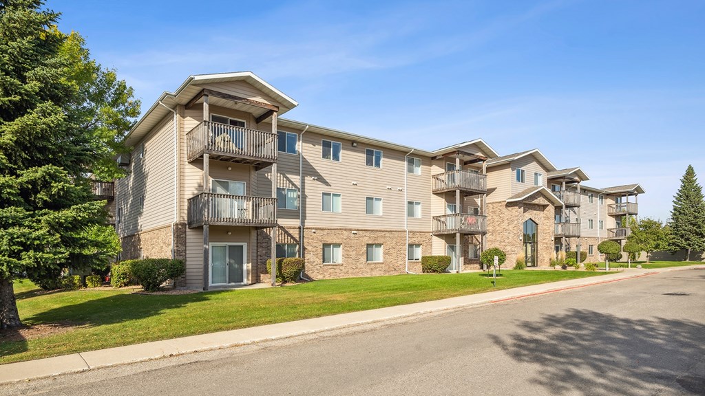 Apartment complex with multiple buildings and balconies.