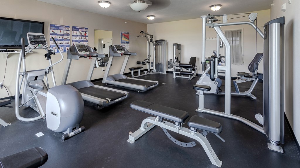 a room filled with lots of different types of exercise equipment