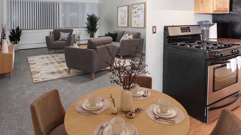 a living room with a table and chairs and a stove